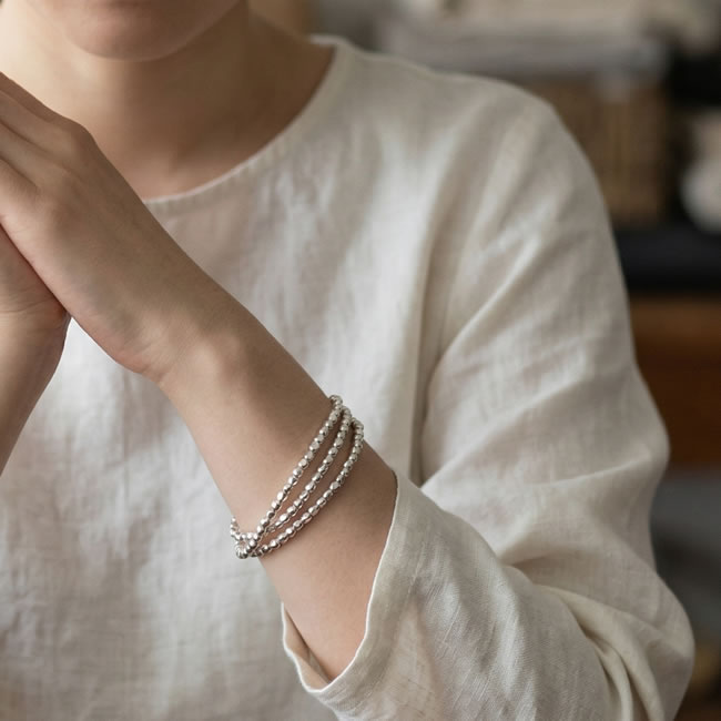 ビーズネックレスをブレスレットとして重ね付けした様子