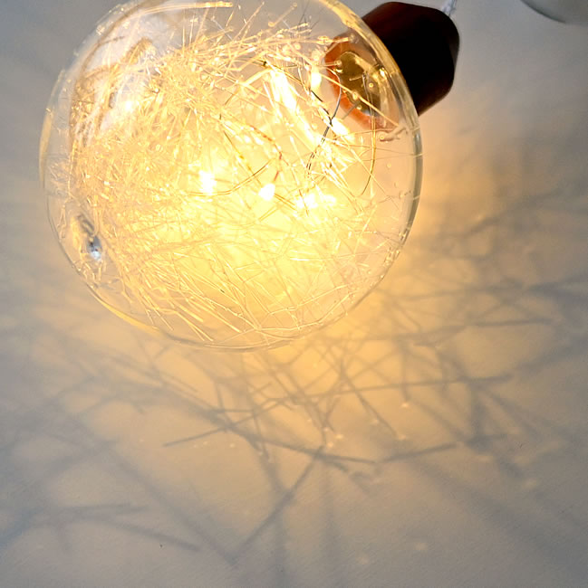最下部のガラス球に灯るLEDと、周囲に広がる繊細な光と影